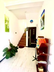 a living room with a staircase and a stair case at Airport Faith Hotel in Katunayaka