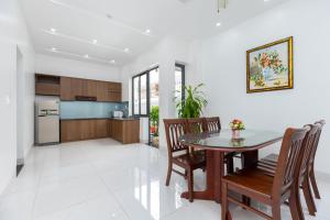 a kitchen and dining room with a table and chairs at Hoàng My Villa D3 in Vung Tau