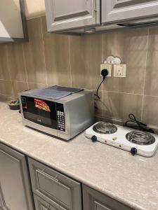 a microwave oven sitting on top of a kitchen counter at Elegant apartment in Jeddah