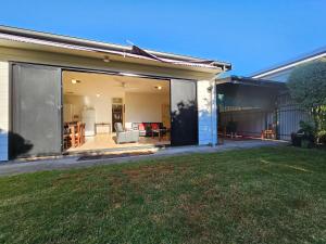 a home with a large glass extension to a backyard at Unley Retreat in Unley