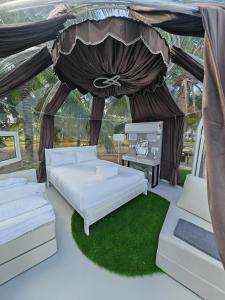 two beds in a gazebo with a canopy at The Coco Journey - Eco Dome in Melaka