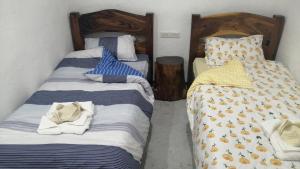 a bedroom with two beds with towels on them at Panda Guest House in Coron
