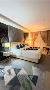 a large bedroom with a large bed and a table at The RN Hotels in Wadi Musa