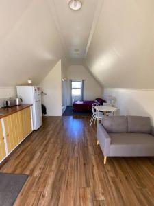 a living room with a couch and a table at The Sugarloaf Homestead in Kyoomba