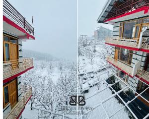 un edificio con nieve en el suelo delante de él en Burwa Breeze By Winsum Stays, en Palchān
