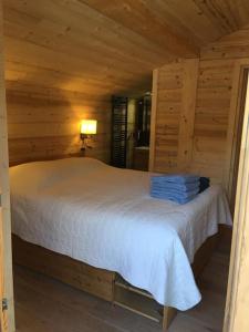 a bedroom with a white bed in a cabin at Individual chalet for up to 12 people maximum in Les Contamines-Montjoie