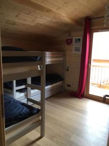 a small room with bunk beds in a cabin at Individual chalet for up to 12 people maximum in Les Contamines-Montjoie