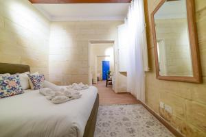 a bedroom with a bed with towels on it at Valletta Collection - Felix Apartments in Valletta