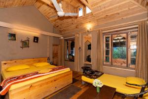 a bedroom with two beds and a wooden ceiling at NotOnMap - H2O House in Chamba
