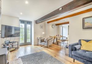 a living room with a couch and a tv at Swallows Barn in Little Snoring