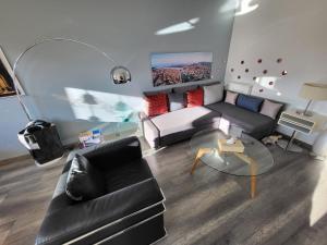 a living room with a couch and a table at Tichnich Apartement - 2 bedrooms in Annemasse