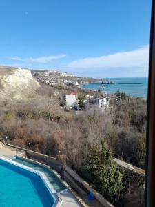 a view of the ocean and a swimming pool at Queen's Palace Balchik apartment in Balchik
