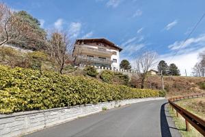 a house on top of a hill with a road at Appartamento Bella Vista in Premeno
