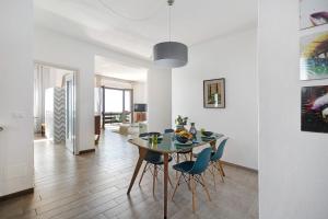 a dining room and living room with a table and chairs at Appartamento Bella Vista in Premeno