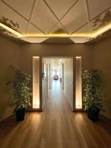 an empty hallway with two potted plants in an office at The Mirage Tangier - 3BR Luxury Sea View with Private Hammam & Jacuzzi in Tangier