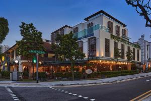 a building on the corner of a street at Nostalgia Hotel in Singapore