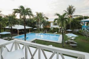 a view of the pool from the balcony of a resort at The Perfect Suite B in Playa Hermosa