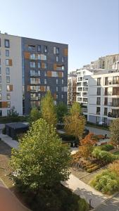 a view of a park with trees and buildings at Like Home Apartments in Kraków