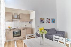 a kitchen and living room with a table and a couch at Al Quindici in Gaeta