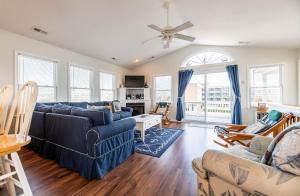 a living room with a blue couch and chairs at Ocean View's in Kill Devil Hills