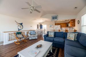 a living room with a blue couch and a table at Ocean View's in Kill Devil Hills