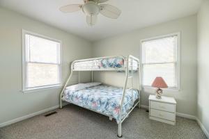 a bedroom with a bunk bed and two windows at Ocean View's in Kill Devil Hills