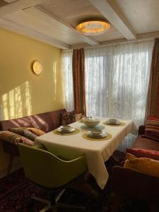 a dining room with a table and a couch at Albliebe am Rosenbühl in Münsingen