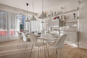 une salle à manger avec une table et des chaises blanches dans l'établissement Parenthese familiale tout pres de la plage, à Pornichet