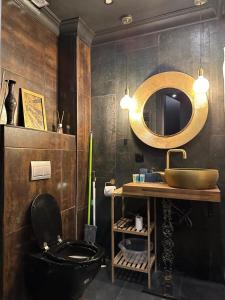 ein Bad mit einem schwarzen WC und einem Waschbecken in der Unterkunft New Gudauri Loft 2 Apartment 129 in Gudauri