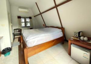 a bedroom with a large bed in a room at Popeye House in Mae Hong Son