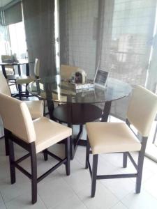 a glass dining room table with a laptop on it at Seaside Serenity in San Juan