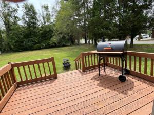 a bbq grill on a wooden deck at 1 king/2queen bd home next to big park in Lexington