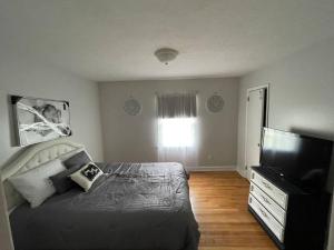 a bedroom with a bed and a flat screen tv at 1 king/2queen bd home next to big park in Lexington