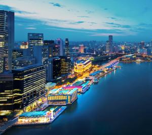 a city skyline at night with a river and buildings at The Fullerton Bay Hotel Singapore in Singapore