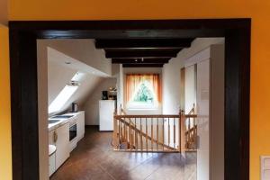 a room with a kitchen and a hallway with a stairway at Ferienwohnung Verena Wunderlich in Schlepzig