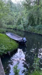 a boat sitting in the middle of a river at Ferienwohnung Verena Wunderlich in Schlepzig
