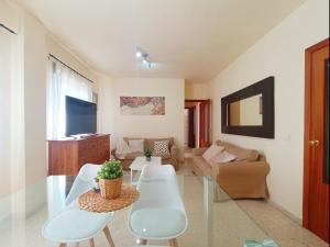 a living room with a couch and a table at Apartamento Tartessos in Seville