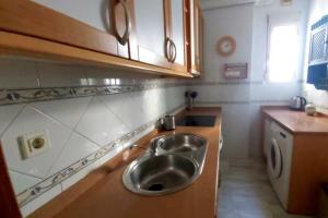 a kitchen with a stainless steel sink in it at Junto a la Calle Betis: El corazón de Triana in Seville