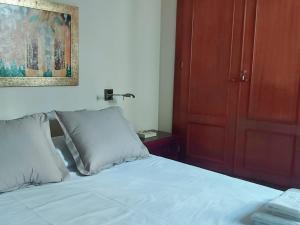 a bedroom with a bed and a red door at Junto a la Calle Betis: El corazón de Triana in Seville