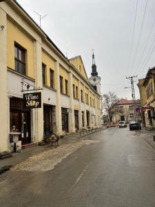 an empty street in a town with a clock tower at Two single beds' room in sremski karlovic center in Sremski Karlovci