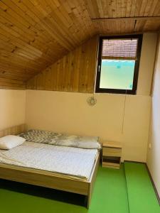 a bedroom with a bed in a room with a window at Two single beds' room in sremski karlovic center in Sremski Karlovci