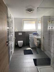a bathroom with a toilet and a sink and a tub at Brunnerhof Urlaub auf dem Land in Hartenstein