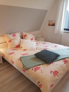 Un dormitorio con una cama con flores rosas. en Kampweg 4, en Cuxhaven