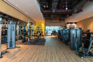 a gym with treadmills and machines in a room at Tamm - Prime Residence with Unrivaled Palm Jumeirah Views in Dubai