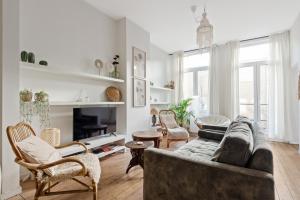 a living room with a couch and chairs at Boho Chic - your bohemian home in Antwerp in Antwerp