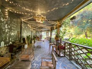 a restaurant with a balcony with tables and chairs at Eco Rose Homestay in Diện Biên Phủ