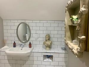a white bathroom with a sink and a mirror at Stunning Cottage in 15 acres in Brampton