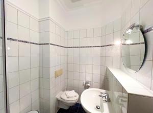 Un baño blanco con lavabo e inodoro. en Villa Perkunos Wohnung Nr. 6, en Heringsdorf 9 fotos más