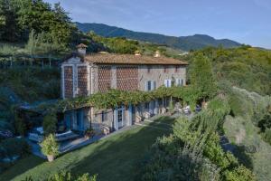 an external view of a large stone house on a hill at Villa Marlia in Lucca