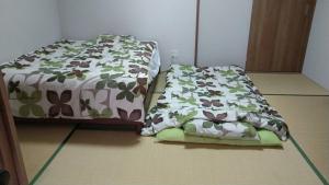 two beds sitting next to each other in a room at base sanablend - Vacation STAY 39607v in Kyotango